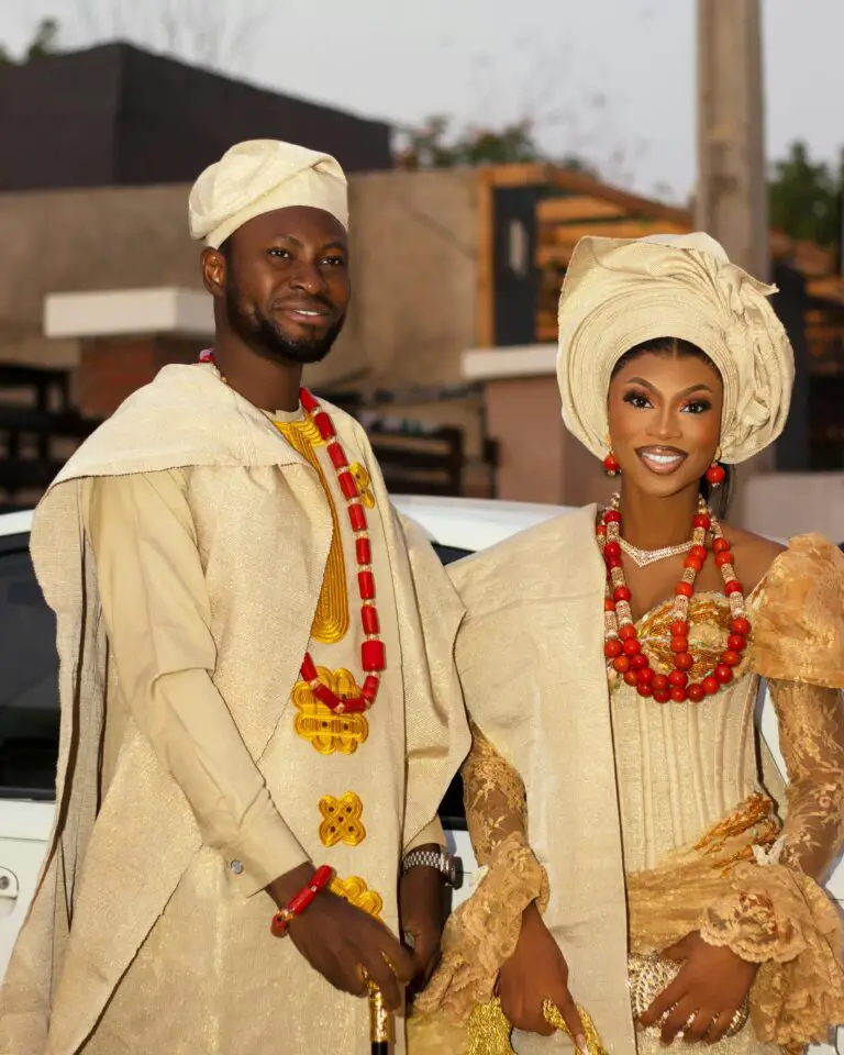 African couple in elegant traditional attire adorned with jewelry, showcasing cultural heritage.